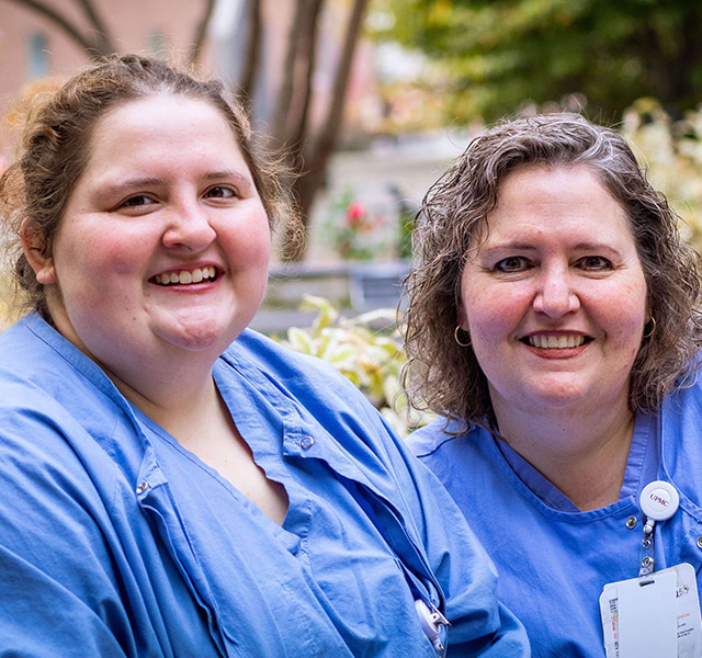 healthcare workers wearing blue scrubs outside hospital 