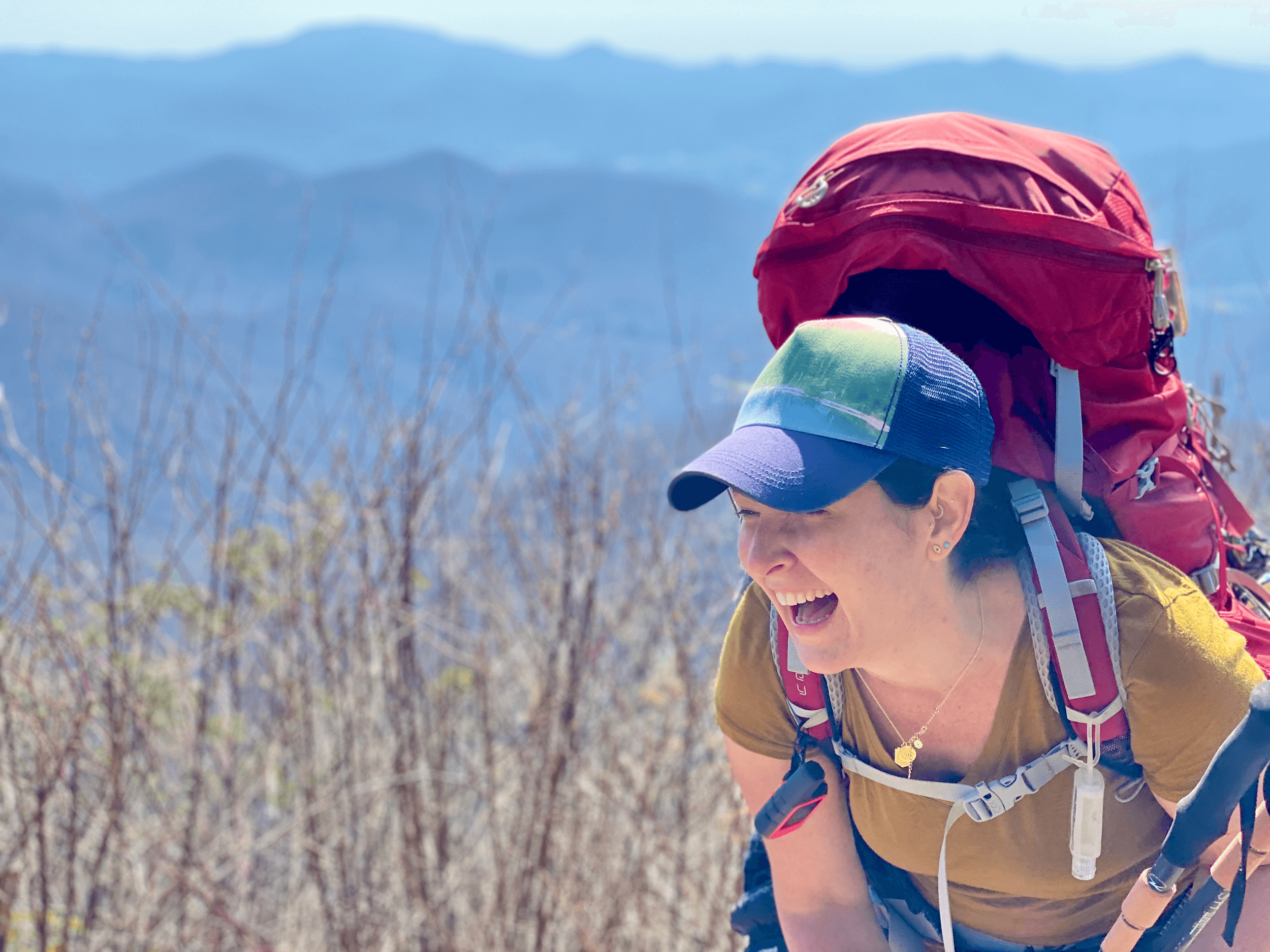 tempImageObIOub Woman on mountain with backpack.